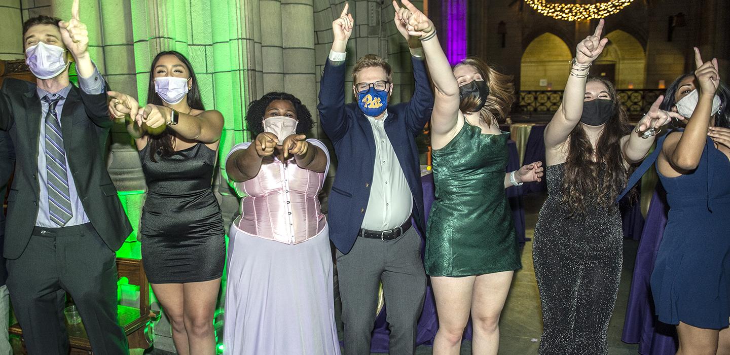 Students raising hands at the Cathedral Ball