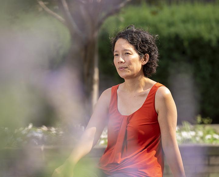 Lillian Chong sitting during an outdoor portrait session on campus.